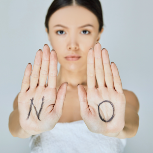 Woman holding hands out saying no